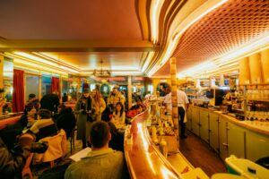 A group of people sitting around a bar